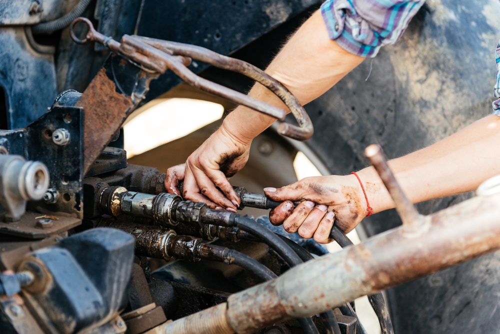 Crop,Anonymous,Dirty,Hands,Of,Female,Technician,Fixing,Engine,On